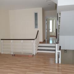 View of staircase area with laminate flooring