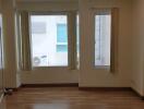 Empty living room with large windows