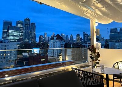 City view from a balcony with outdoor seating