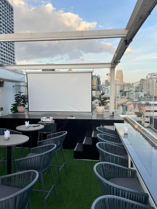 Rooftop area with seating and a projector screen