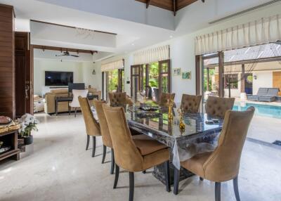 Spacious living area with dining table and view of the pool