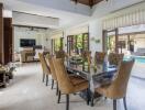 Spacious living area with dining table and view of the pool