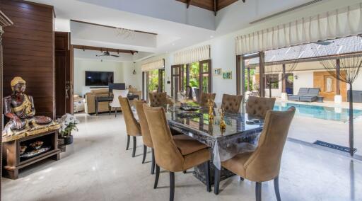 Spacious living area with dining table and view of the pool