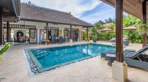 Outdoor view of a swimming pool area with adjacent seating