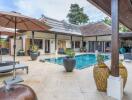 Luxurious outdoor pool area with lounge chairs and potted plants