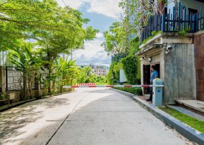 Gated entrance with lush greenery