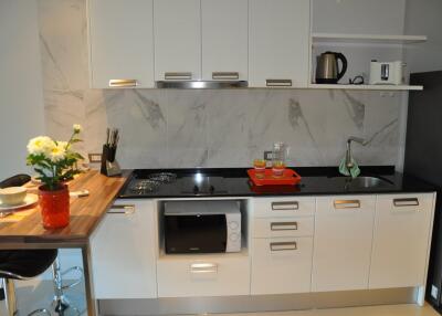 Modern kitchen with white cabinets and marble backsplash