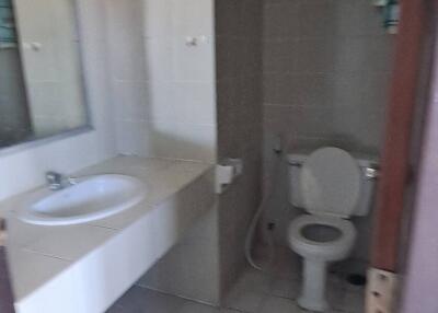 Bathroom with sink, mirror, and toilet