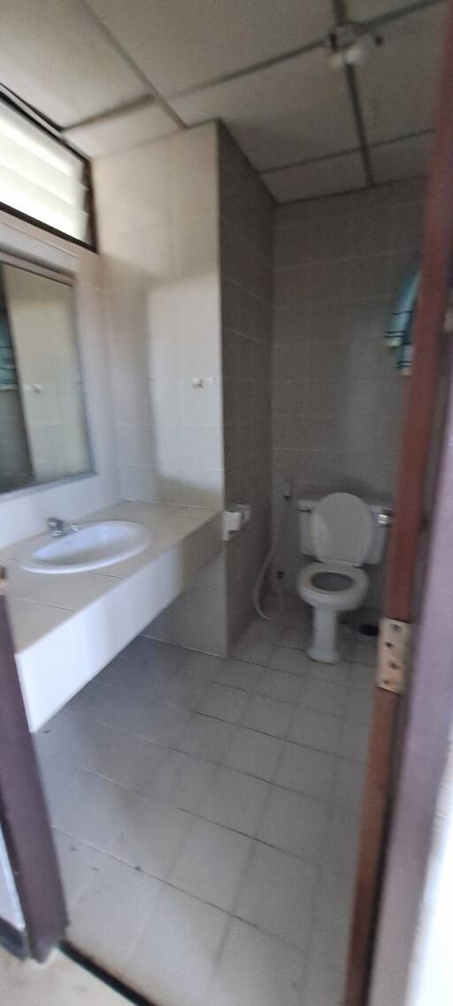 Bathroom with sink, mirror, and toilet