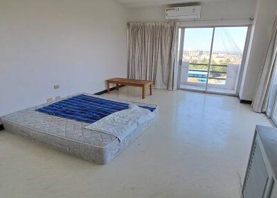 Spacious bedroom with large windows and balcony access