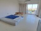 Spacious bedroom with large windows and balcony access