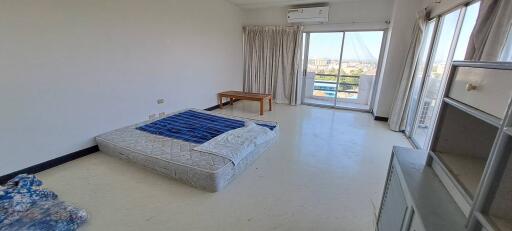 Spacious bedroom with large windows and balcony access