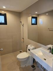 Modern bathroom with large mirror and two windows