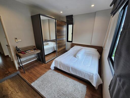 Modern Bedroom with Wood Flooring and Large Wardrobe