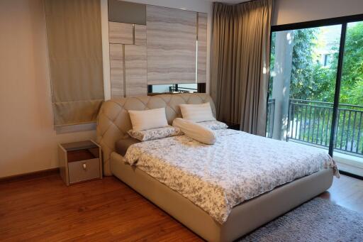 Modern bedroom with large window and balcony