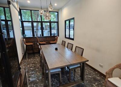 Spacious dining room with large windows and modern lighting