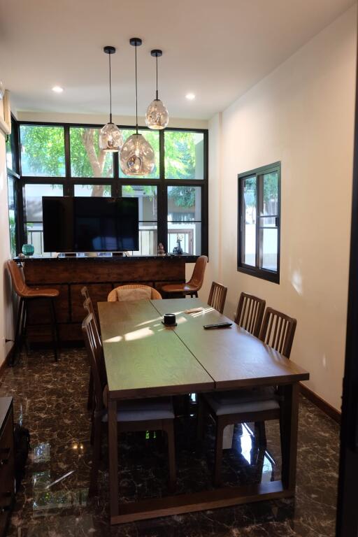 Dining room with modern furnishings and large windows