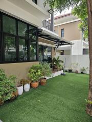 Outdoor garden with potted plants and artificial grass