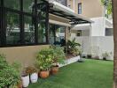 Outdoor garden with potted plants and artificial grass