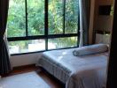 Cozy bedroom with large window and natural light