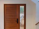 Well-lit entryway with modern wooden door