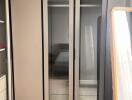 Modern bedroom with a large wardrobe and mirror