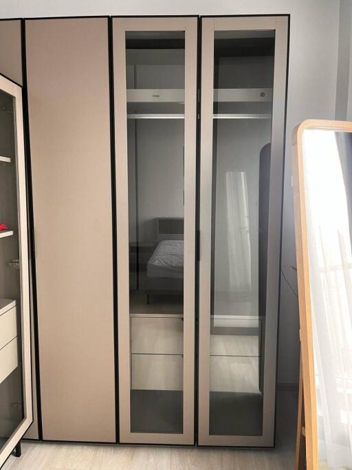 Modern bedroom with a large wardrobe and mirror