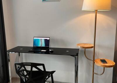 Home office with desk and floor lamp