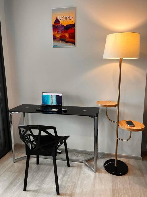 Home office with desk and floor lamp