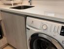 Laundry room with washing machine and sink