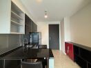 Modern kitchen with black countertops and cabinets