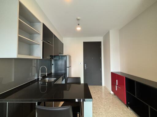 Modern kitchen with black countertops and cabinets