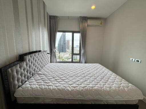 Bedroom with a large bed and a city view