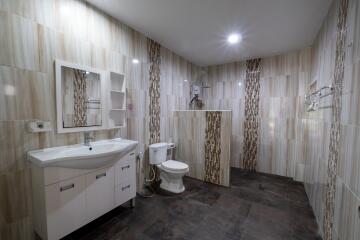 Modern bathroom with vanity, toilet, and shower