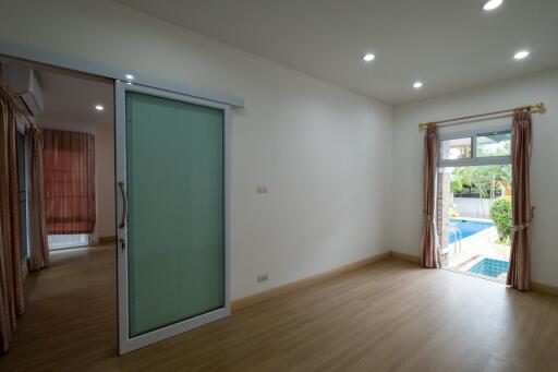 Bedroom with sliding door and view to pool