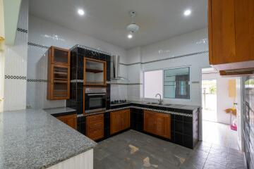 Modern kitchen with wooden cabinets and granite countertops