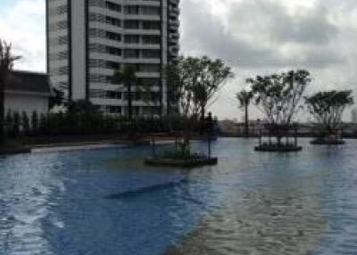 View of the swimming pool with a high-rise building in the background