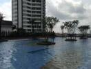 View of the swimming pool with a high-rise building in the background