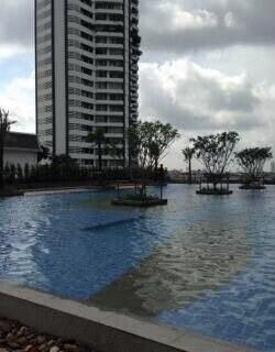 View of the swimming pool with a high-rise building in the background