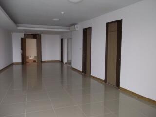 Spacious living area with tiled floor and multiple doors