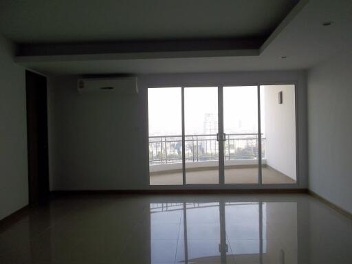 Spacious living room with large windows and balcony