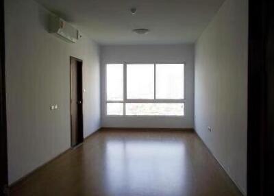 A spacious empty living room with a large window