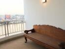 Balcony with wooden bench and city view