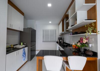 Modern kitchen with white cabinets and black countertops