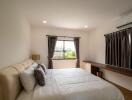 Well-lit bedroom with double bed and large window