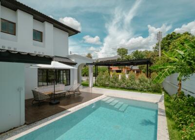 Outdoor area with a swimming pool and seating area