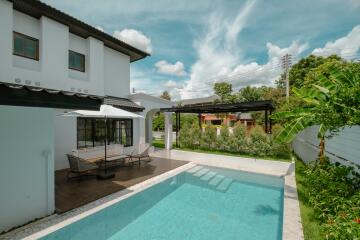 Outdoor area with a swimming pool and seating area