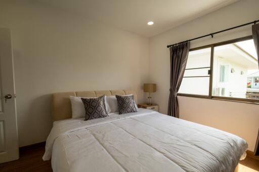 Cozy bedroom with double bed and window