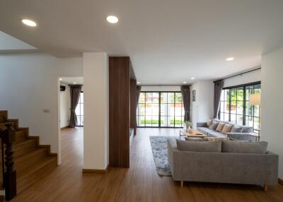 Spacious living room with large windows and modern furniture