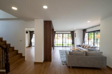 Spacious living room with large windows and modern furniture